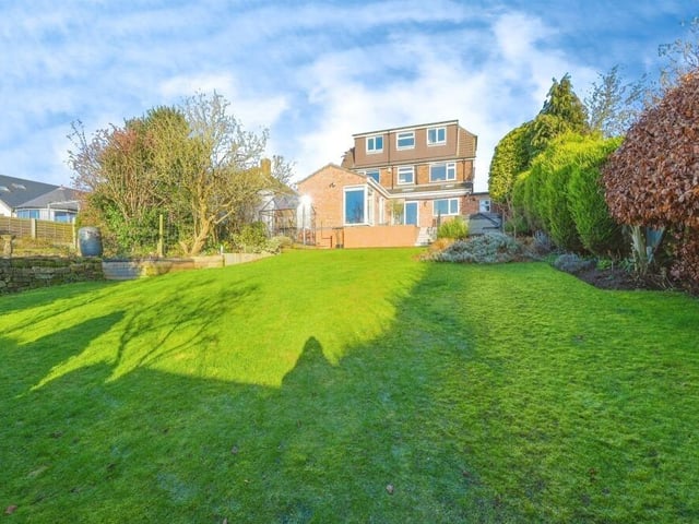 You've seen the front, now let's take a look at the view from the rear of the £425,000 house, with an initial glance of the well-designed back garden. As you can see, a lengthy lawn is flanked by private hedgerows.