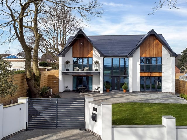 A modern, remote-controlled electric gated entrance leads onto a good-sized block paved driveway with turning space.