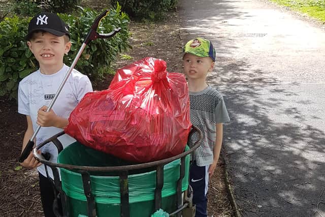 Two youngsters with the fruits of their labours after a litter-pick at Racecourse Park in Mansfield.