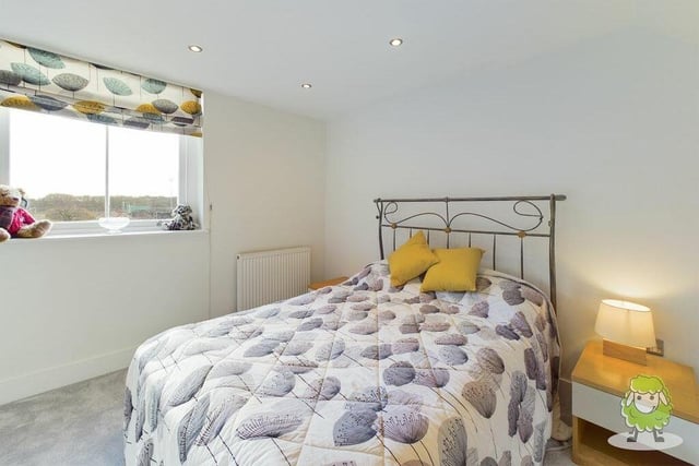 Let's look around the first floor of the three-storey building now. This is the first of the three bedrooms, which has fitted wardrobes and offers fine views towards Berry Hill Park.