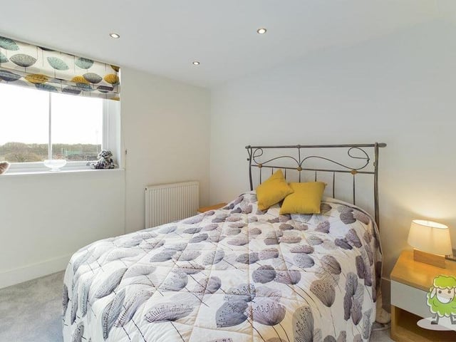 Let's look around the first floor of the three-storey building now. This is the first of the three bedrooms, which has fitted wardrobes and offers fine views towards Berry Hill Park.