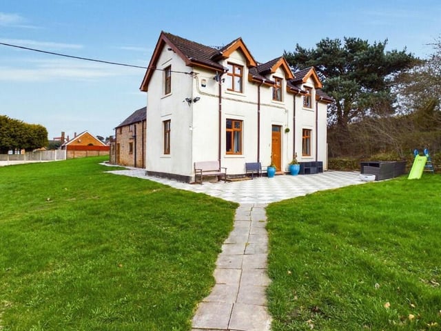 Before we step inside the £700,000 Kirkby farmhouse, here's another shot of its attractive exterior, with a pathway leading to a patio area and the front door.