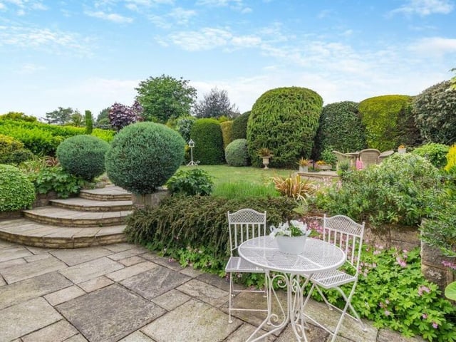 Possibly the jewel in the crown of the Beverley Drive bungalow is the glorious garden at the back of the property. It includes an extensive stone patio that runs the width of the bungalow, and steps that lead to a lawn and another patio with space for seating.