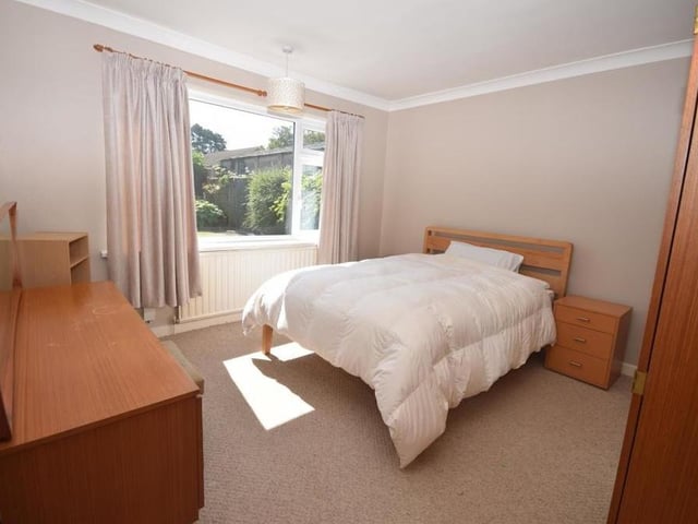 Here is one of two double bedrooms on the ground floor. Bright, it overlooks the back of the bungalow and features a radiator and coving to the ceiling.