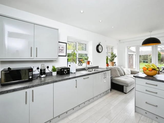 The kitchen features sleek countertops, ample storage space, and modern appliances.