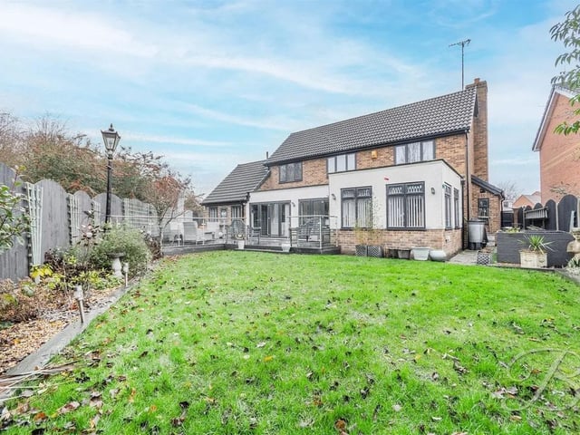 To the rear, a generous lawned garden offers plenty of outdoor space for recreation. The garden is private and well-maintained, with room for seating, dining, or planting.