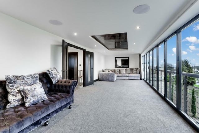 As well as the open-plan space, the first floor of the £1.2 million property boasts this bright and lengthy living room.