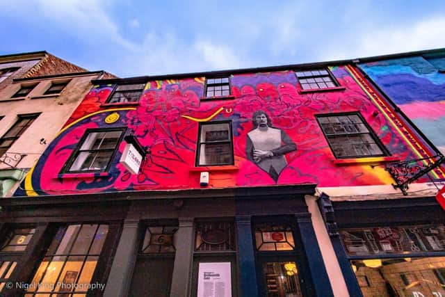 Five local artists were enlisted to design and create murals on some of the buildings
