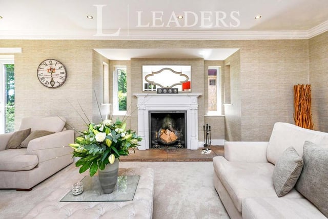 The first reception room we look at on the ground floor of the £1.95 million Ravenshead pile is this delightful drawing room. At the heart of it is a feature fireplace with open fire. To the ceiling, there are spotlights and decorative coving.