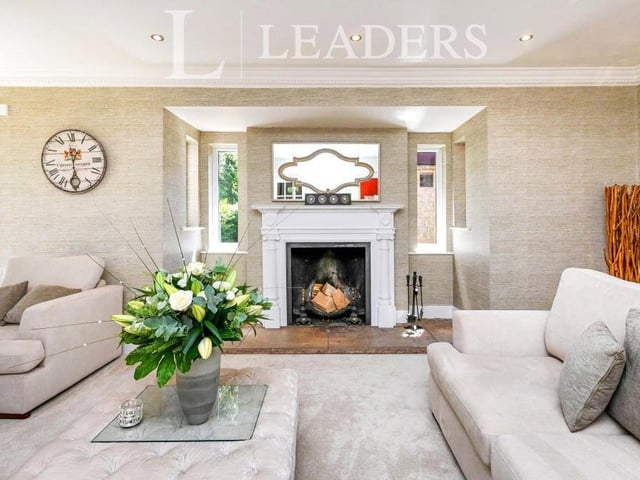 The first reception room we look at on the ground floor of the £1.95 million Ravenshead pile is this delightful drawing room. At the heart of it is a feature fireplace with open fire. To the ceiling, there are spotlights and decorative coving.