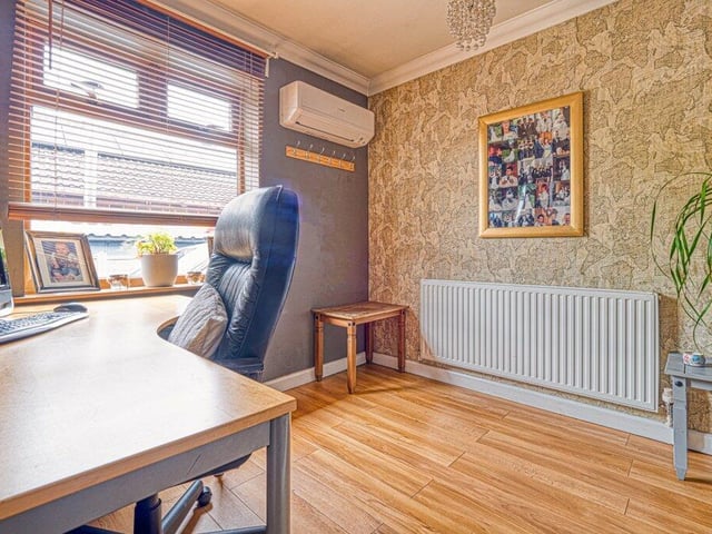 Three of the bedrooms can be found in the ground floor of the property. They include this one, which has been converted into an office that's ideal for working from home.
