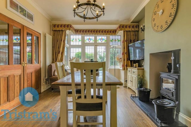 On the opposite side of the hallway to the lounge is this delightful dining area, which also has an inset space for a wood-burner and a double-glazed bay window to the rear.