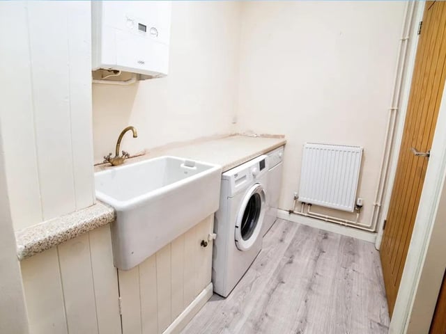 The property benefits from a handy utility room