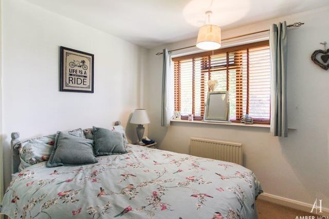 The other two bedrooms are at the back of the property, including this one, which has a carpeted floor, radiator and double-glazed window.