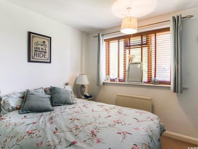 The other two bedrooms are at the back of the property, including this one, which has a carpeted floor, radiator and double-glazed window.