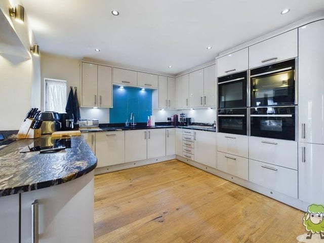 The modern kitchen oozes class and gloss. It offers a full array of sleek units, while high-end Neff appliances include two double hide-and-slide ovens, a steamer, a combi-microwave, induction hob and extractor.