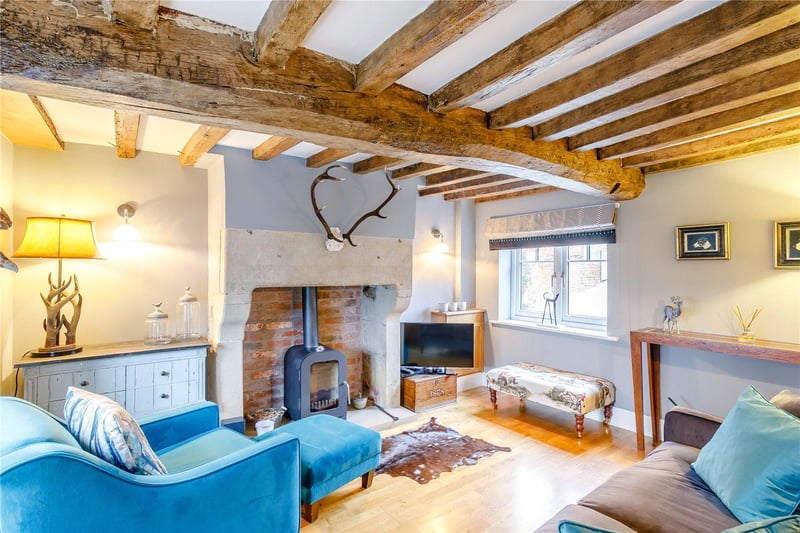A delightful, dual-aspect snug is accessible off the kitchen and features original exposed beams, oak flooring and the original stone fireplace with an inset log burner.