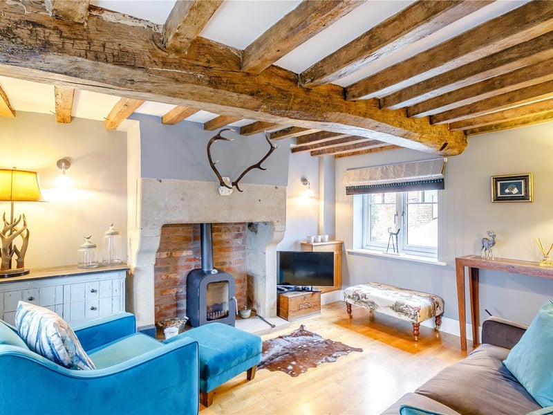 A delightful, dual-aspect snug is accessible off the kitchen and features original exposed beams, oak flooring and the original stone fireplace with an inset log burner.