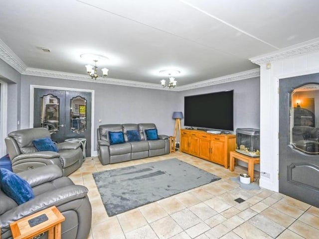 Here is the living room or lounge that is part of an open-plan area on the first floor that also includes the kitchen. An ideal spot to relax in front of the telly.