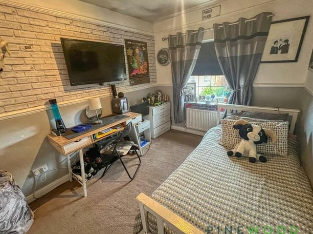 The third bedroom at the Kirkby house is also full of life. Facing the back, it includes integrated storage space and a fitted carpet.