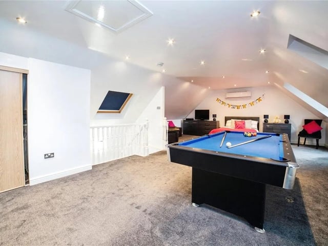 Occupying the entire upstairs floor, this attic bedroom is a spacious retreat that combines modern amenities with distinctive character.