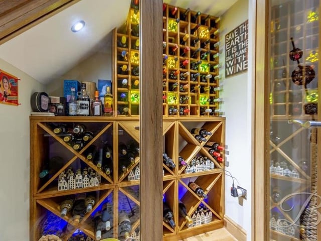 Before heading up to the bedrooms, it would be remiss not to check out this quirky wine cupboard, which has been neatly fitted underneath the stairs in the hallway.