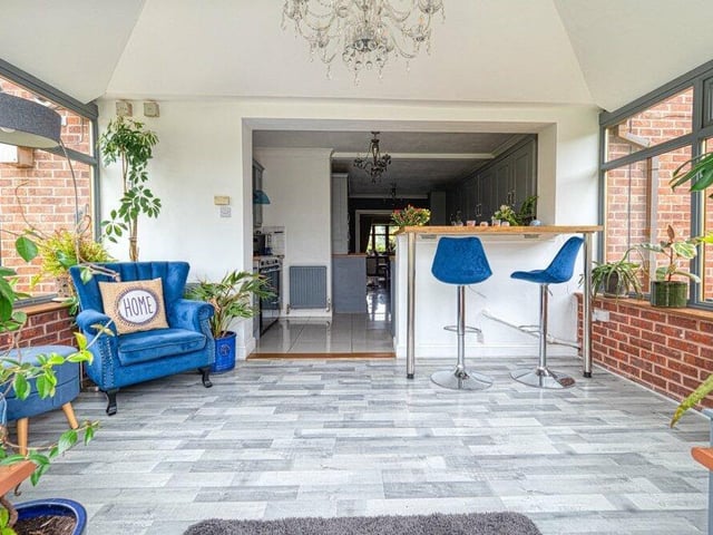Relax and watch the world go by in the entertainment room next to the kitchen and breakfast bar area.