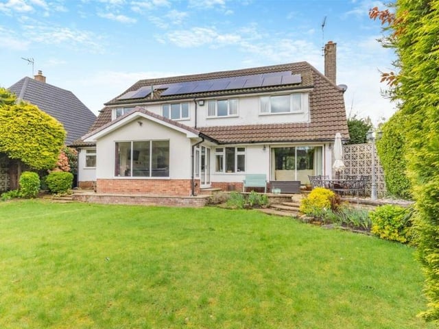 As we step outside, here is a view of the rear of The Avenue property. You can see the dining kitchen extension, the solar panels on the roof and one of the garden patios.