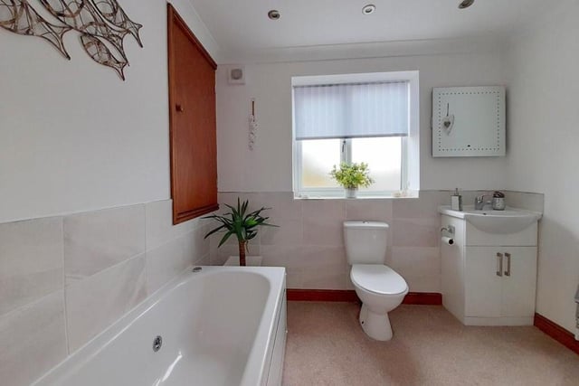 The family bathroom on the first floor includes a panelled spa bath with a shower attachment to the mixer tap. There is also a low-flush WC and pedestal wash hand basin, while a cupboard houses a gas combi boiler.