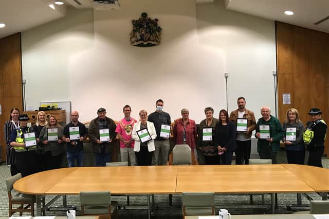 Representatives from various organisations holding their certificates