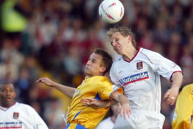 Paul Trollope of Northampton is challenged by Tom Curtis.