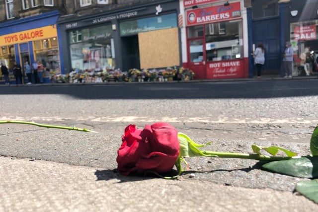 Red roses were laid along the pavement of Morningside Road in tribute to the toddler