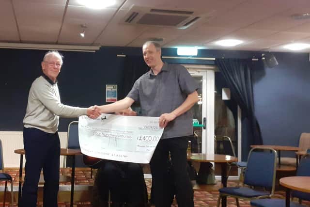 Dave Kemp presenting the cheque to Joe Edge representing PACT and Changing Lives through Horses.