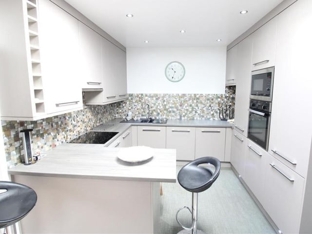 Our next port of call at the £255,000 bungalow is this refitted kitchen, which has a range of high-gloss base and wall units, plus a built-in fridge freezer, dishwasher, washing machine, oven hob and extractor hood. Work surfaces extend to a breakfast bar, while there is a skylight window to the roof.