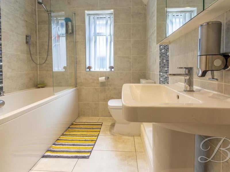 The final room to look at within the house is this family bathroom. It consists of a panelled bath with screen and overhead shower, low-flush WC and wash hand basin.