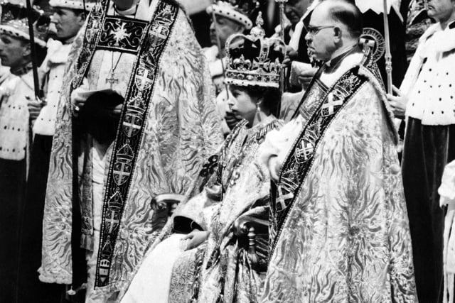 Queen Elizabeth II, surrounded by the bishop of Durham Lord Michael Ramsay (L) and the bishop of Bath and Wells Lord Harold Bradfield, receives homage and allegiance from her subjects during her coronation ceremony on June 2, 1953 in Westminster Abbey, London. (Photo by INTERCONTINENTALE / AFP) (Photo by -/INTERCONTINENTALE/AFP via Getty Images)