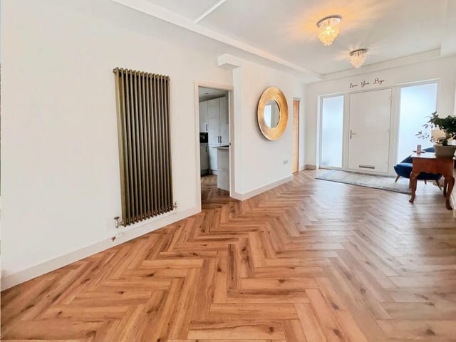 The entrance hall sets the tone with sleek luxury vinyl flooring and a natural flow into the main living space.