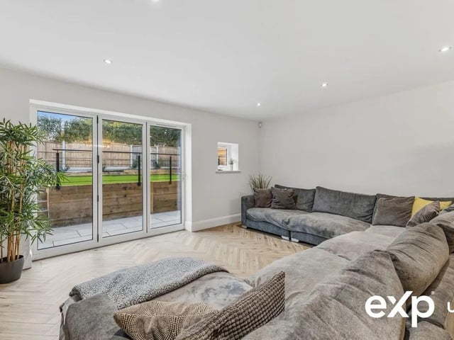 In the open plan kitchen/dining/living space there is also more than enough room here for relaxed seating in front of show stopping bi-folding doors that open out to the patio and frame the rear garden.