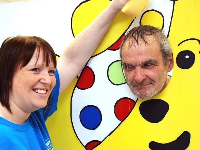 Peter Gregory, manager of Boots in Sutton gets a soaking by a member of staff, Hannah Walton in aid of Children in Need.