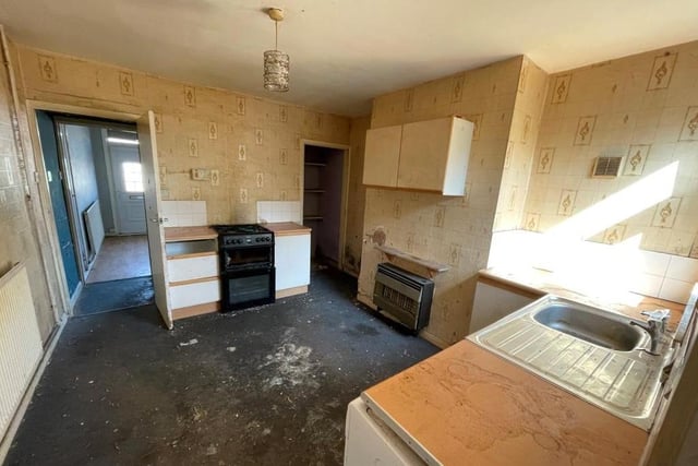 From the lounge, it's across the inner hallway into this good-sized kitchen. A room ripe for a refurbishment project, it boasts base units, a sink with single drainer and a window overlooking the back of the house.