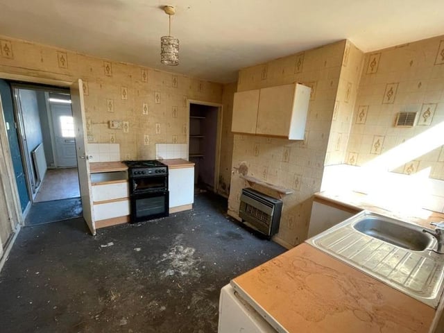 From the lounge, it's across the inner hallway into this good-sized kitchen. A room ripe for a refurbishment project, it boasts base units, a sink with single drainer and a window overlooking the back of the house.