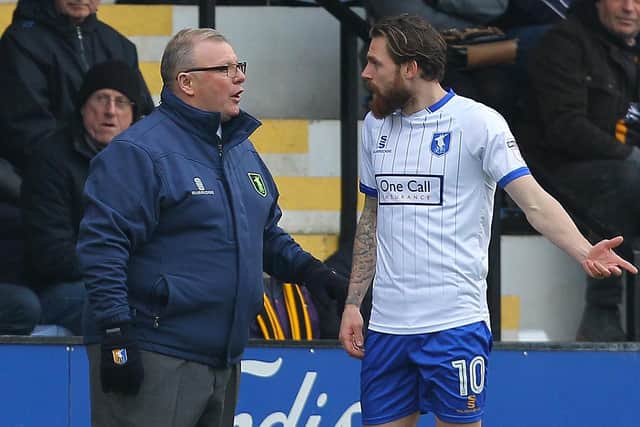 Steve Evans gives his instructions to Paul Anderson at Cambridge.