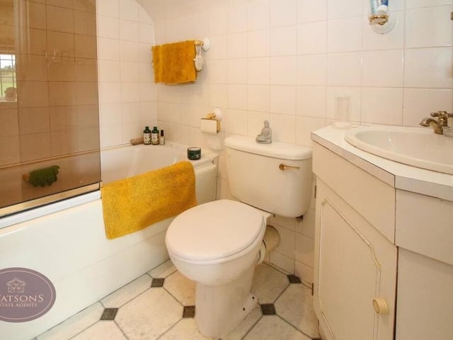 The bathroom within the annexe is a three-piece suite in white, consisting of a bath with shower over, a wall-mounted sink and a WC.