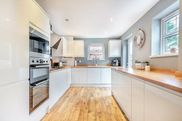 Next stop is the contemporary, fitted kitchen/diner, which has been recently improved to a high standard. It comes with high-gloss cabinets comprising wall cupboards, base units and drawers, complemented by wood-effect worktops.