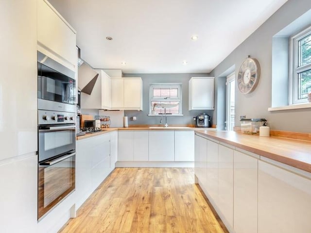 Next stop is the contemporary, fitted kitchen/diner, which has been recently improved to a high standard. It comes with high-gloss cabinets comprising wall cupboards, base units and drawers, complemented by wood-effect worktops.