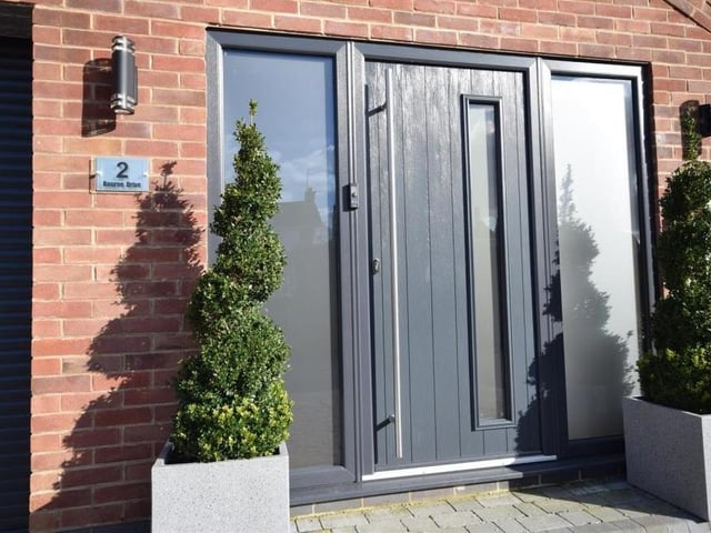 Let's step inside to begin our tour of the Ravenshead house. This stylish front door sits next to the integral garage, which has power and lighting.