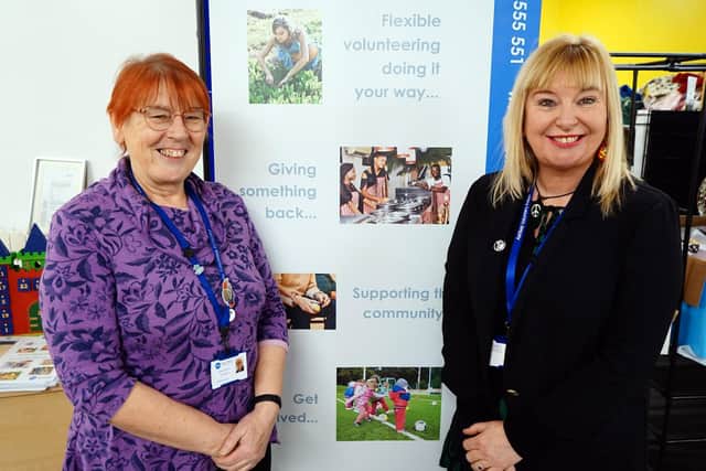 Teresa Jackson (left) hands over the chief executive officer's reins at Ashfield Voluntary Action to Deborah Hill.