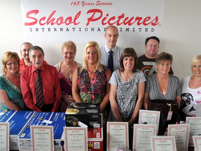 On Thursday, staff members at School Pictures International in Mansfield were honoured for their long service, collectively totalling 165 years. Pictured from left to right are: Julie Kinnison, Paul Wheatley, Terry Hines, Christine Harwood, Wendy Broadfoot, Noel Bradshaw, Liz Felton, Martin Clover, Linda Oxley, and Gail Hagerty.