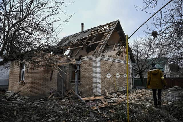 Kyril Kolcheryn, aged 21, walks near a house destroyed by shelling in the town of Stoyanka, west of Kiev, Ukraine.