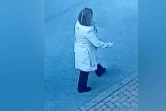 Police have released this picture of a woman who was pictured walking nearby and who police believe may have information to assist them.